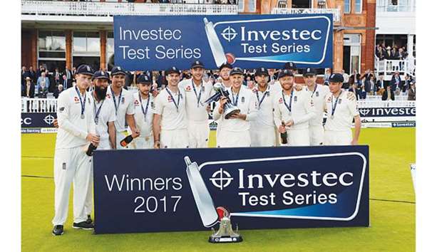 Englandu2019s Joe Root and teammates celebrate with the trophy after winning the Test series against West Indies on Saturday. (Reuters)