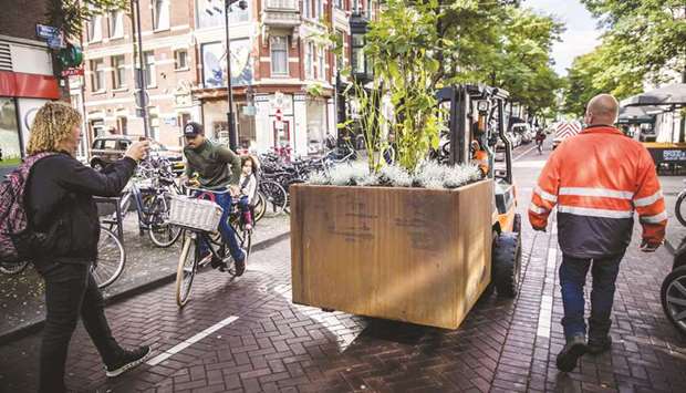 Rotterdam city workers use a forklift to install heavy-duty flower boxes as a security measure to prevent attacks with vehicles.