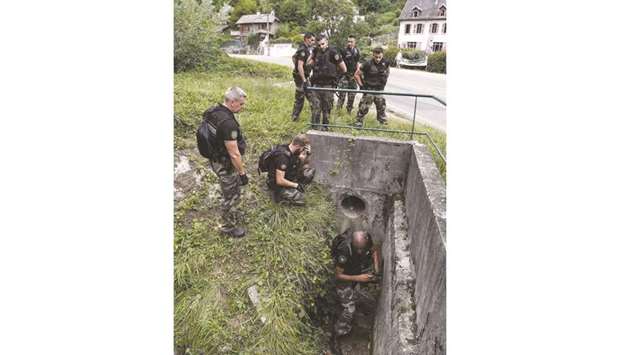 French gendarmes search for evidence in Pont-de-Beauvoisin after the disappearance of a nine-year-old girl.