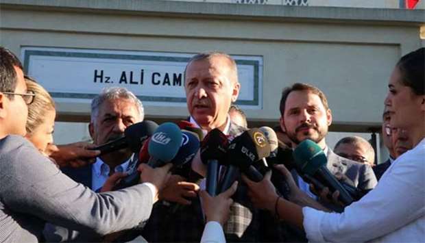 Turkish President Recep Tayyip Erdogan talks to media after Eid al-Adha prayers in Istanbul on Friday.