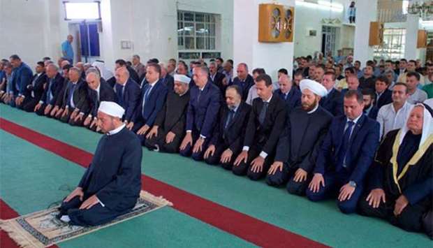 President Bashar al-Assad performing the morning Eid al-Adha prayer at the Grand Mosque of Qara, in the Qalamoun region on the outskirts of the Syrian capital Damascus, on Friday.