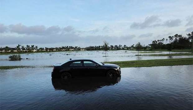 An abandoned car sits in a flooded street the morning after Hurricane Irma swept through the area in Bonita Springs, Florida on Monday.
