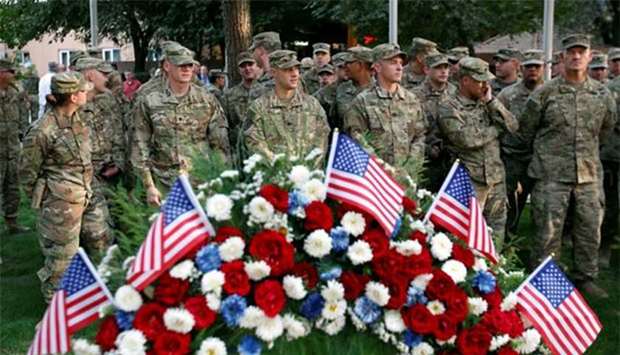 US soldiers take part in a memorial ceremony to commemorate the16th anniversary of the 9/11 attacks, in Kabul on Monday.