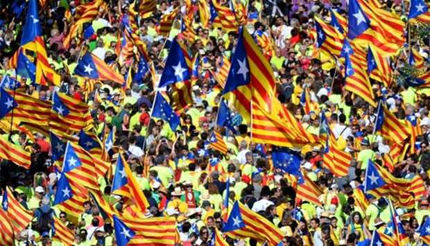 People wave 'Esteladas' (pro-independence Catalan flags) as they gather during a pro-independence demonstration, in Barcelona on Monday.