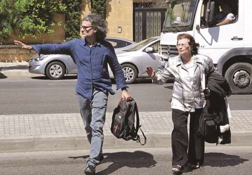 French-Lebanese director Ziad Doueiri (left), arrives at the Military Tribunal in Beirut yesterday.