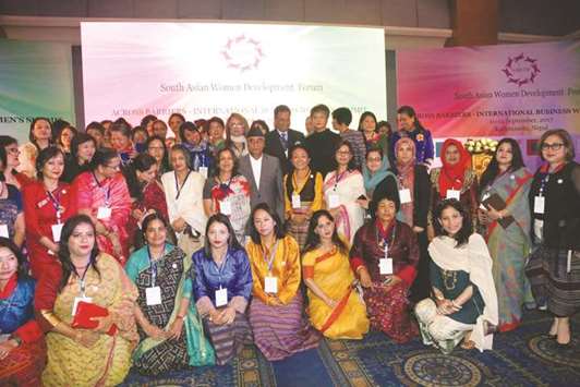 Nepalu2019s Prime Minister Sher Bahadur Deuba, centre, poses with participants of Across Barriers-International Business Womenu2019s Summit in Kathmandu yesterday.