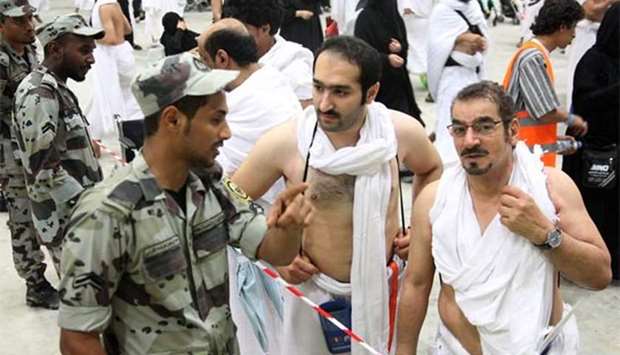 Saudi security personnel assist pilgrims as they head to take part in the symbolic stoning of the devil at the Jamarat Bridge in Mina, near Makkah, which marks the final major rite of the Haj on Friday.