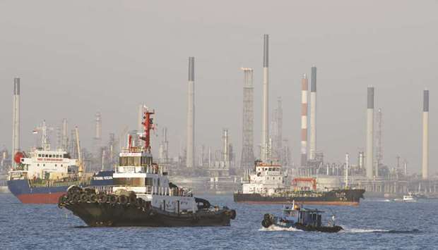 Vessels pass an oil refinery in the waters off the southern coast of Singapore. Singapore refinery margins, a benchmark for Asia, have jumped by around a third since Harvey made landfall last Friday to $10.60 a barrel, the highest since January 2016 and the highest for this time of year in a decade.