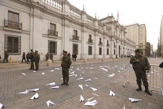 Paper planes with pictures of people missing since the 1973-1990 dictatorship in Chile are seen outside the presidential palace La Moneda, in Santiago yesterday, during a rally to commemorate the 44th anniversary of the military coup led by General Augusto Pinochet that deposed late president Salvador Allende.