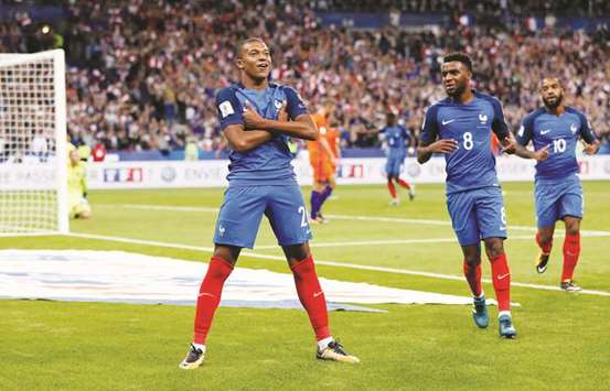 Franceu2019s Kylian Mbappe (left) celebrates after scoring a goal against the Netherlands as teammates Thomas Lemar (centre) and Alexandre Lacazette join in. (Reuters)