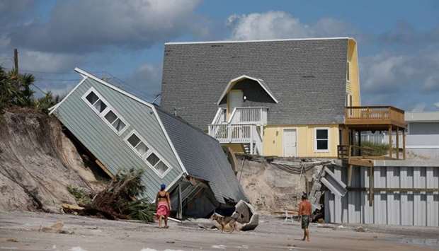 Local residents look at a collapsed coastal house after Hurricane Irma passed the area in Vilano Beach, Florida, US.
