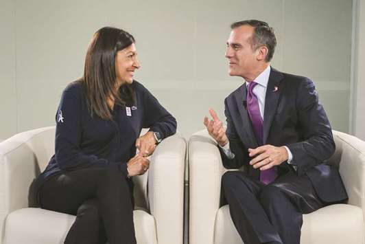 Mayor of Paris Anne Hidalgo (L) and Los Angeles Mayor Eric Garcetti chat ahead of an International Olympic Committee (IOC) session in Lima. For the first time in history, the Olympics will confirm two Summer Games host cities at the same time today, when Paris is handed hosting rights for 2024 and Los Angeles wins 2028.