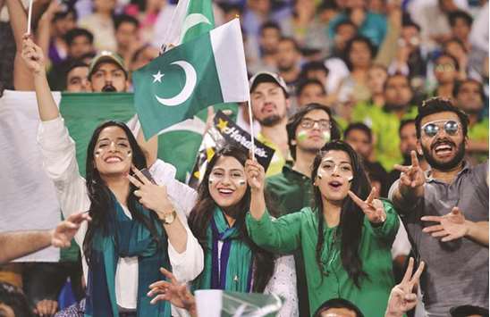 Spectators cheer as they watch the first Twenty20 international match between the World XI and Pakistan in Lahore yesterday. (AFP)