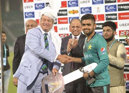 Pakistan player Babar Azam receives man of the match award from ICC director Giles Clarke during a ceremony after the first Twenty20 international match between the World XI and Pakistan in Lahore yesterday. (AFP)