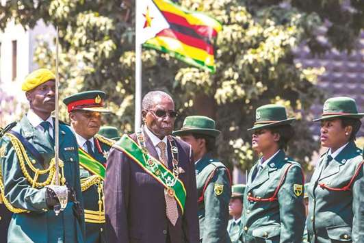 President Robert Mugabe inspects a guard of honour during the official opening of the Parliament in Harare, the last session ahead of a general election in 2018.