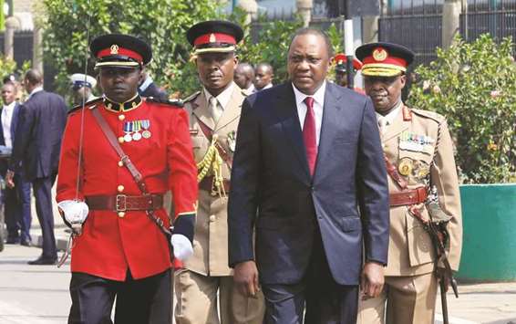 Kenyau2019s President Uhuru Kenyatta inspects the honour guard before the opening of the Parliament outside the National Assembly Chamber in Nairobi.