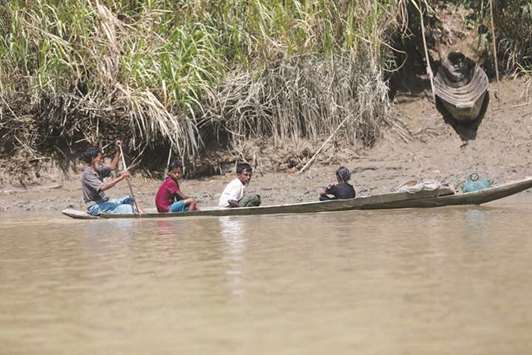 Rohingya people are seen on a boat near a village outside Buthidaung, Rakhine State, Myanmar.