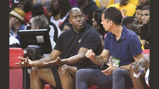 Lakers president of basketball operations Magic Johnson (left) with general manager Rob Pelinka at Thomas and Mack Centre for the Summer League opener against the Clippers. (Los Angeles Times)