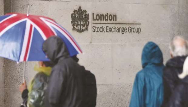 Pedestrians walk past the London Stock Exchange. The FTSE 100 rose 0.1% yesterday.