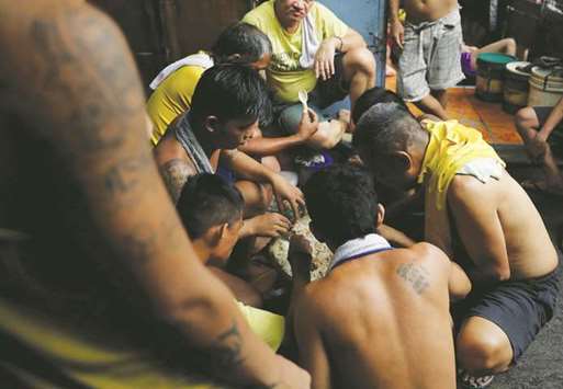 Detainees eat their food rations inside the city jail of Quezon City, Metro Manila.