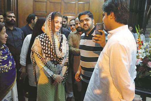 Maryam Nawaz takes a picture with a supporter at a rally in Lahore.
