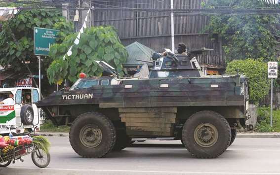 An armoured personnel carrier (APC) drives along a main national highway of Mahayahay town after the intense fights between soldiers and pro-IS militants group, who have taken over parts of Marawi, in Iligan City, yesterday.