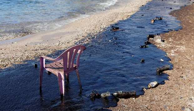 Oil that leaked from an oil tanker that sank on September 10, is seen on a beach on Salamina island
