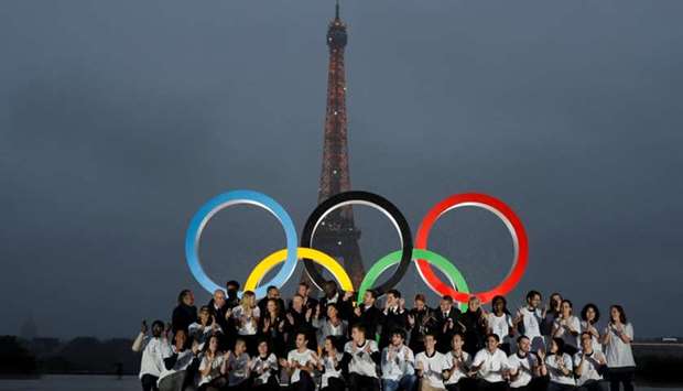 Parisians, athletes and officials pose in front of Olympic rings to celebrate the IOC official announcement that Paris won the 2024 Olynpic bid during a ceremony at the Trocadero square in Paris