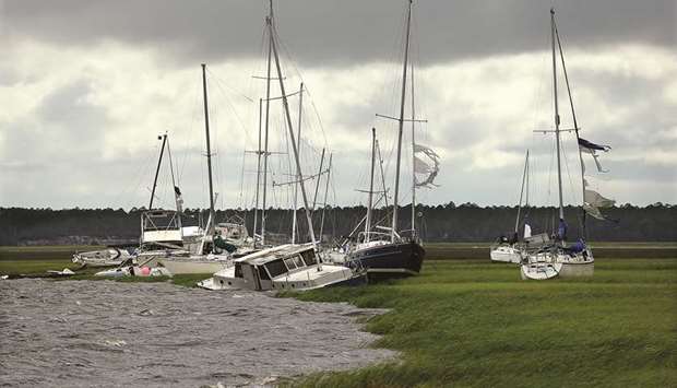 Dozens of boats are blown into the marsh, some sinking, near Langs Marina after Hurricane Irma hit the town on Monday.