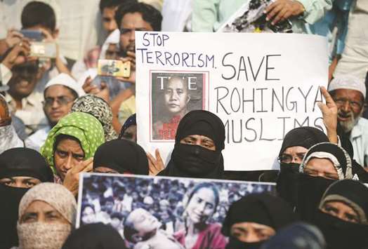 Demonstrators hold placards as they take part in a protest against the treatment of Rohingya Muslims in Myanmar, as they try to march towards Myanmar embassy in New Delhi yesterday.
