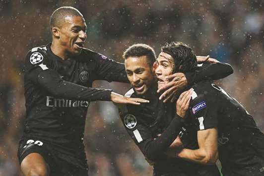 Paris Saint-Germainu2019s Neymar (centre) celebrates with teammates Kylian Mbappe (left) and Edinson Cavani after scoring the opening goal of the UEFA Champions League match against Celtic at Celtic Park in Glasgow on Tuesday. (AFP)