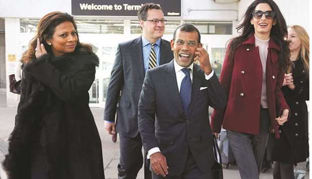 In this file photo, former Maldives president Mohamed Nasheed, centre, his wife Laila Ali, left, and British lawyer Amal Clooney look on after Nasheed arrived at Heathrow airport in London.