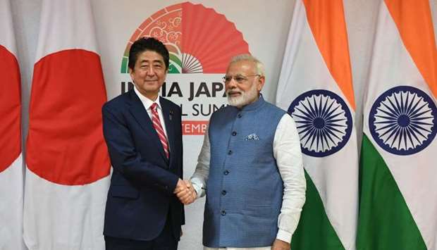 Japanese Prime Minister Shinzo Abe (L) and Indian Prime Minister Narendra Modi