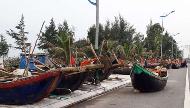 Fishing boat are seen moved onto a road near a beach in the central province of Thanh Hoa
