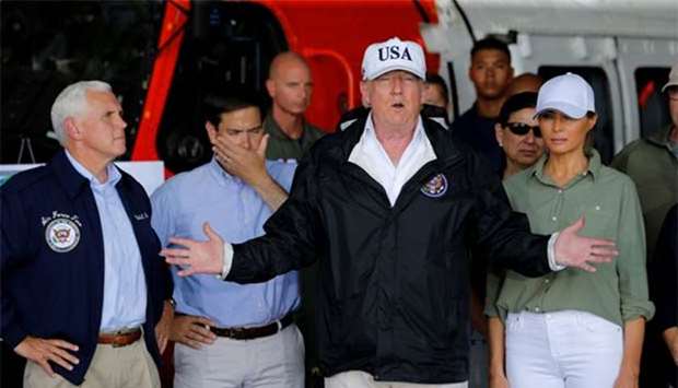 President Donald Trump speaks as First Lady Melania Trump, Vice President Mike Pence and Senator Marco Rubio (second left) watch while receiving a briefing on Hurricane Irma relief efforts in Fort Myers, Florida on Thursday.