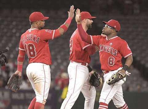 Los Angeles Angels players Luis Valbuena (No 18), Kaleb Cowart (No 22) and Eric Young Jr. celebrate after a game against the Houston Astros at Angel Stadium of Anaheim. PICTURE: USA TODAY Sports