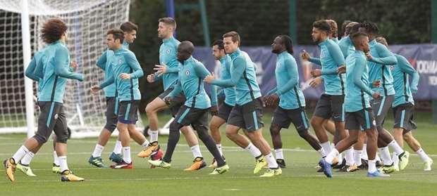 Chelseau2019s French midfielder Nu2019Golo Kante (fifth from left) warms up with teammates during a team training session at Chelseau2019s Cobham training facility in Stoke Du2019Abernon, southwest of London. (AFP)