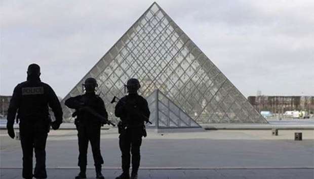 French police are seen near the Louvre Pyramid in Paris earlier this year.