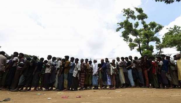 Rohingya refugees wait in line for relief supplies in the Bangladeshi town of Ukhia on Friday.