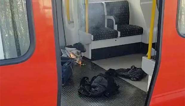 Personal belongings and a bucket with an item on fire inside it are seen on the floor of an underground train carriage at Parsons Green station in west London on Friday, in this image taken from social media.