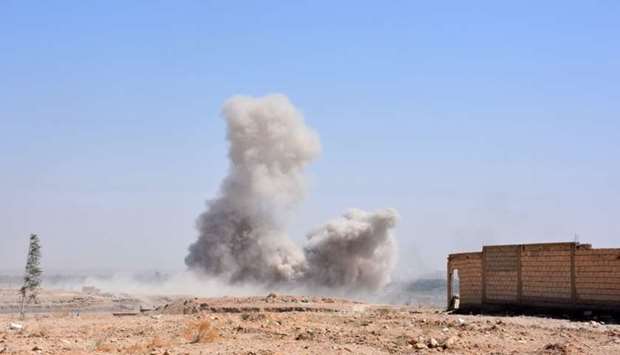Smoke billows as Syrian pro-government forces advance in the Jamiyet al-Ruwad neighbourhood, on the northern outskirts of Deir Ezzor.
