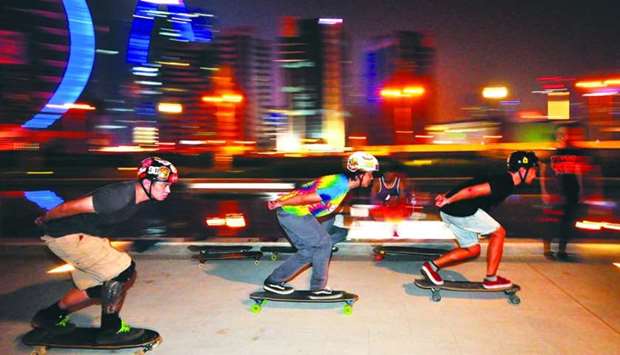 Riders zoom past participants at the 'freestyle session' organised by the Doha Longboarding Crew at the Hotel Park. PICTURE: Peter Alagos