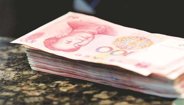 One hundred yuan banknotes are seen at a commercial bank in Beijing. Chinese banks extended more credit than expected in August, buoyed by demand from home buyers and companies.