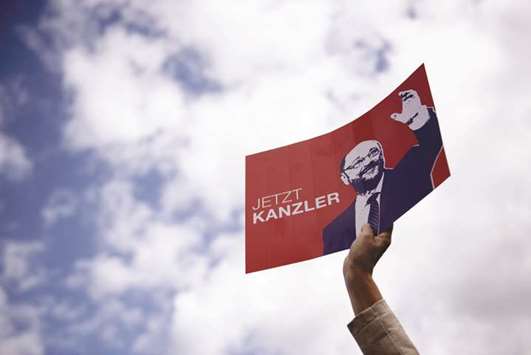 A supporter holds a sign depicting Schulz and reading u2018now chancelloru2019 during an election campaign in Potsdam for the SPDu2019s candidate for chancellor.