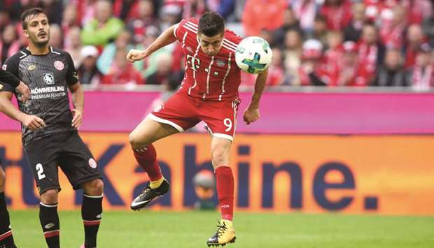 Bayern Munichu2019s Robert Lewandowski scores during the Bundesliga match against Mainz in Munich yesterday. (Reuters)