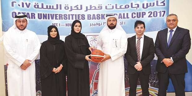 Qatar Basketball Federationu2019s secretary general Ali al-Malki (third from right) and Hamad Bin Khalifa Universityu2019s vice-president of student affairs Ms. Maryam al-Mannai (third from left) pose with other officials after signing a Memorandum of Understanding (MoU) yesterday.