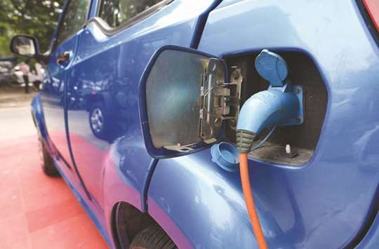 Mahindrau2019s electric car u201ce2o Plusu201d plugged in for charging at a showroom in New Delhi.