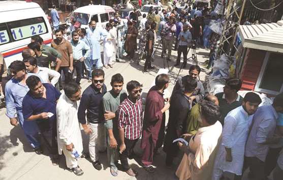 Voters queue to cast their ballots in a by-election in Lahore yesterday.