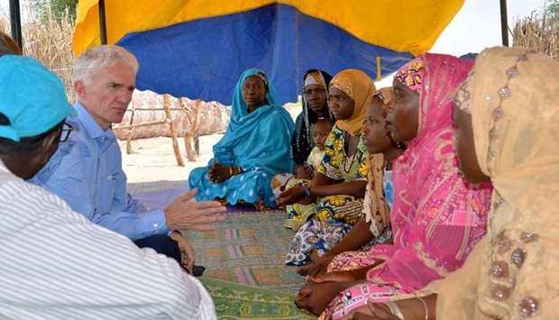 United Nations Under-Secretary-General for Humanitarian Affairs (OCHA) and Emergency Relief Coordinator Mark Lowcock (L) speaking with women at a UN camp for refugees and internally displaced persons (IDP) in NGagam, some 50km from Diffa, southeast Niger, close to the Nigerian border.  AFP