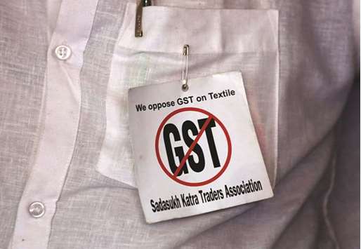 A cloth merchant wears a message pinned to his shirt during a protest against implementation of Goods and Services Tax (GST) on textiles in Kolkata.